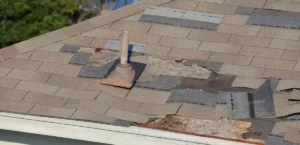 insurance claim roof contractor inspecting storm damaged roof
